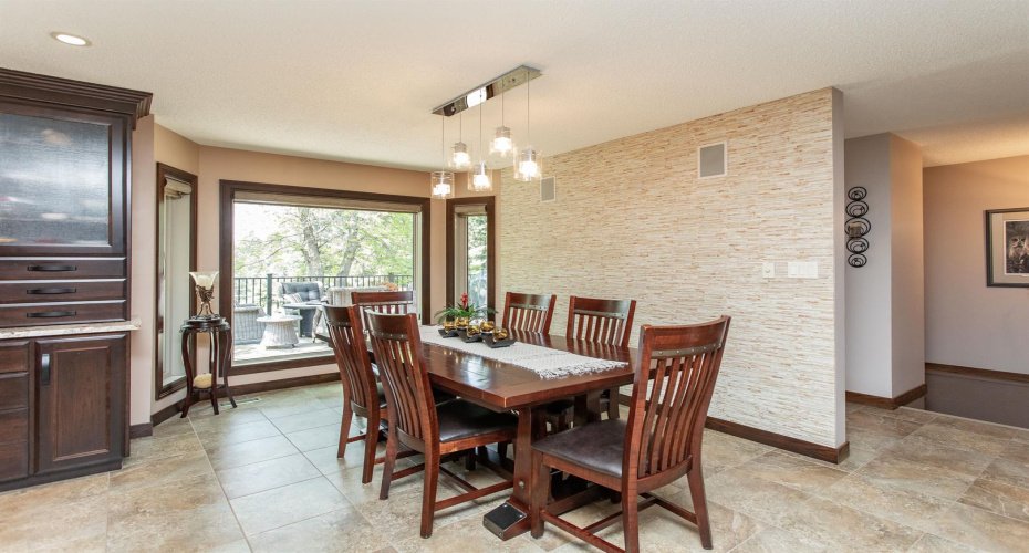 Travertine accent wall and large window overlooking the beautiful deck and yard