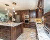 Upgraded stainless appliances and a large island for entertaining