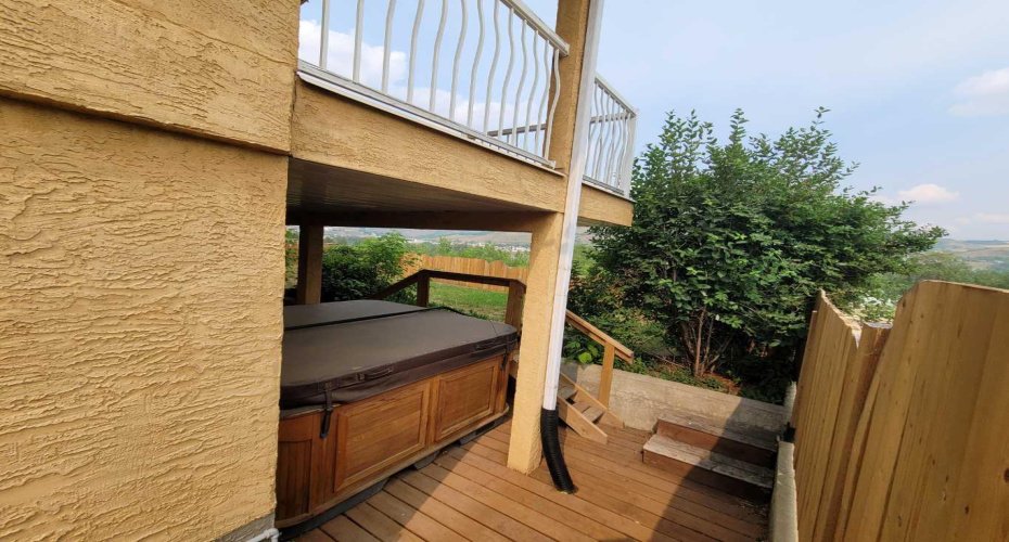 Side yard, hot tub on patio