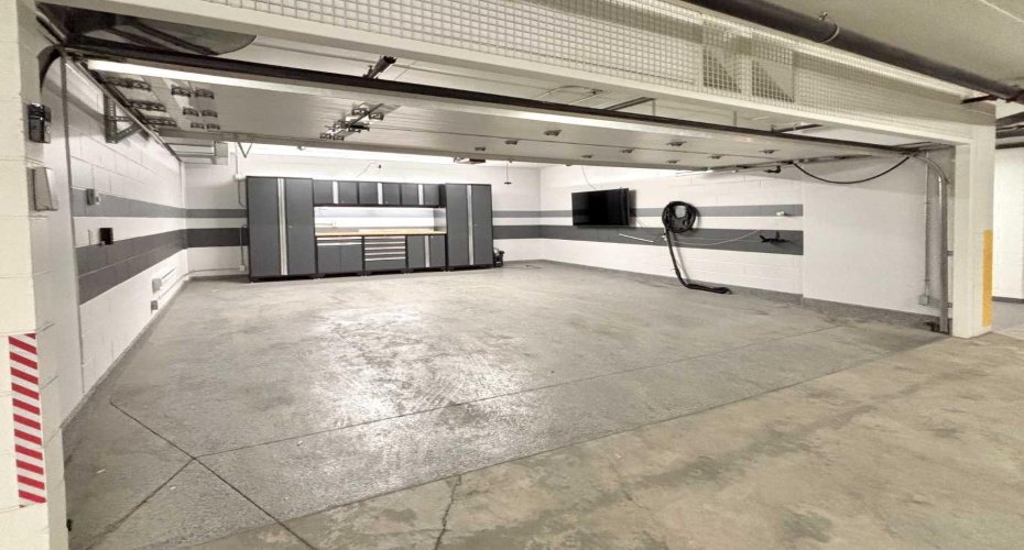 Upgraded $150,000 titled 2-car garage complete with an epoxy floor, custom cabinetry