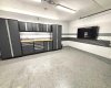 Upgraded $150,000 titled 2-car garage complete with an epoxy floor, custom cabinetry