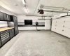 Upgraded $150,000 titled 2-car garage complete with an epoxy floor, custom cabinetry