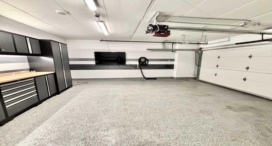 Upgraded $150,000 titled 2-car garage complete with an epoxy floor, custom cabinetry