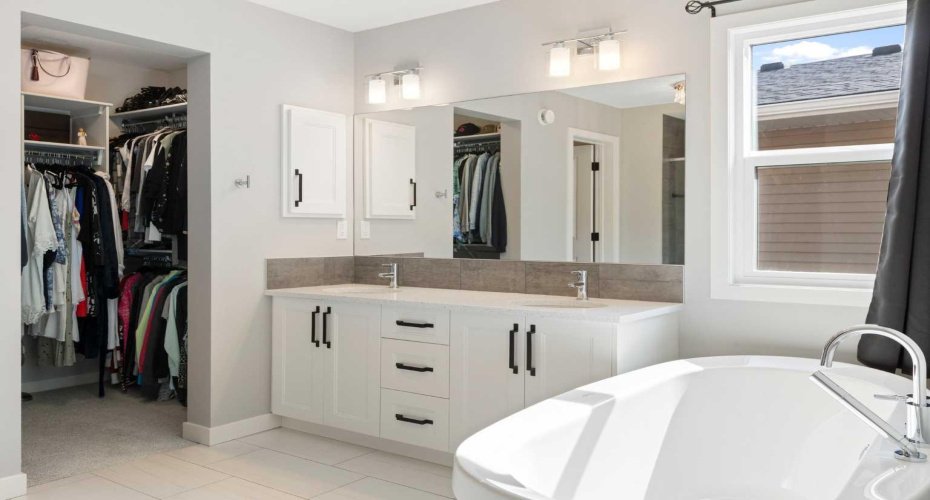 Soaker tub view to walk-in closet