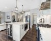 Built-in beverage fridge, microwave and black stainless-steel appliances including gas stove