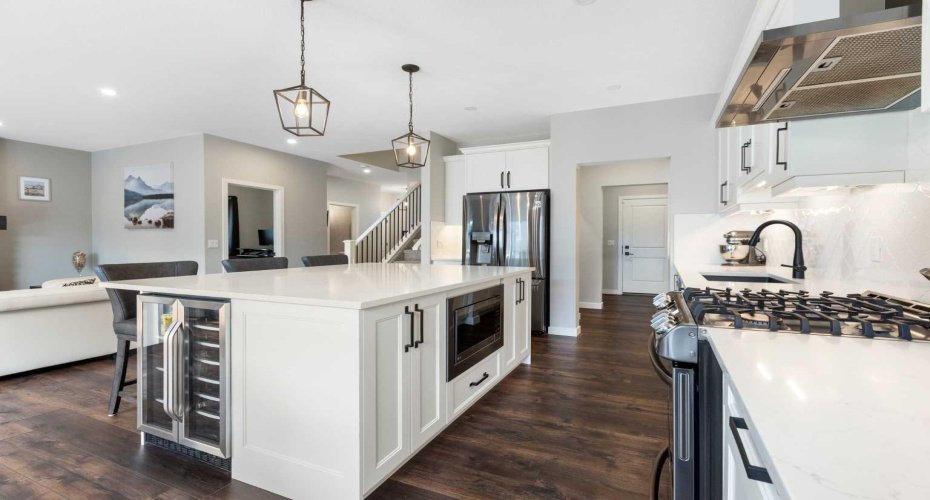Built-in beverage fridge, microwave and black stainless-steel appliances including gas stove