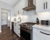 Soft-close cabinets with storage drawers for pots and pans; under-cabinet lighting and ample counter space for food prep
