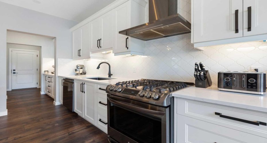 Soft-close cabinets with storage drawers for pots and pans; under-cabinet lighting and ample counter space for food prep