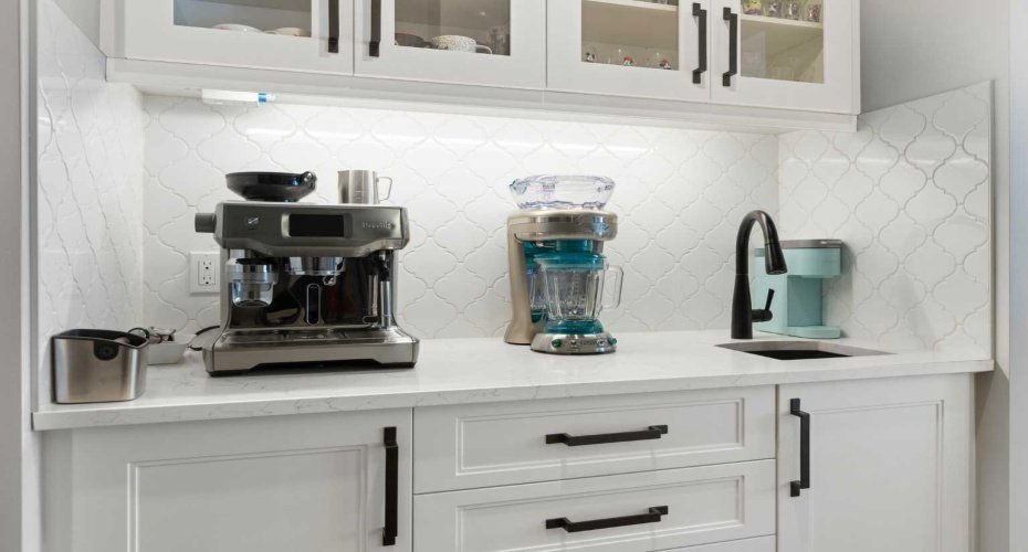 Custom butler's pantry with prep sink and additional cabinets and soft-close drawers