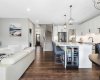 Warm, rich LVP throughout the main floor; high ceilings; stairs to upper level