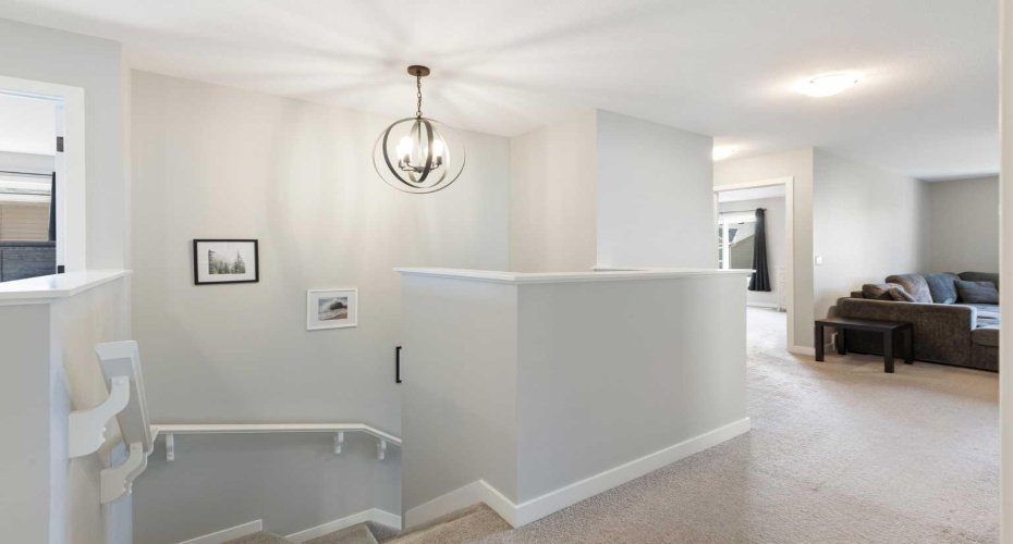 Top of stairs with view to comfy family room