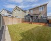 Fenced back yard with view of composite deck that runs the length of the house;  gazebo and hot tub included
