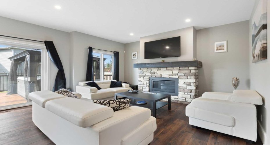 The living room centers around the stylish natural gas fireplace