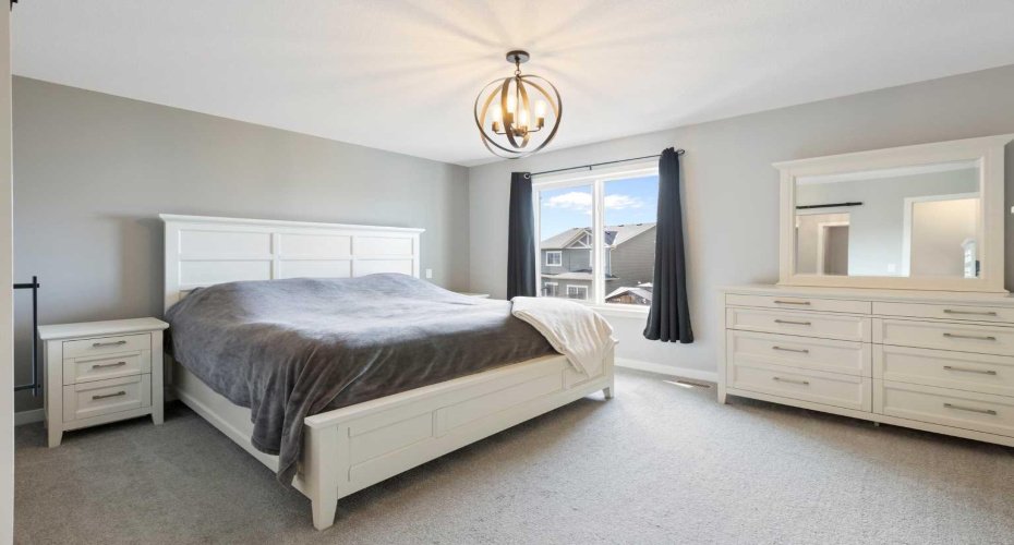 Spacious primary bedroom can accommodate a king-sized bed and side tables