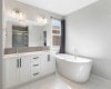 Luxury 5-piece ensuite with in-floor heating, dual vanity, stand-alone soaker tub, rainfall shower and walk-in closet