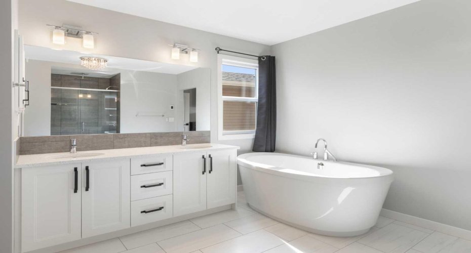 Luxury 5-piece ensuite with in-floor heating, dual vanity, stand-alone soaker tub, rainfall shower and walk-in closet