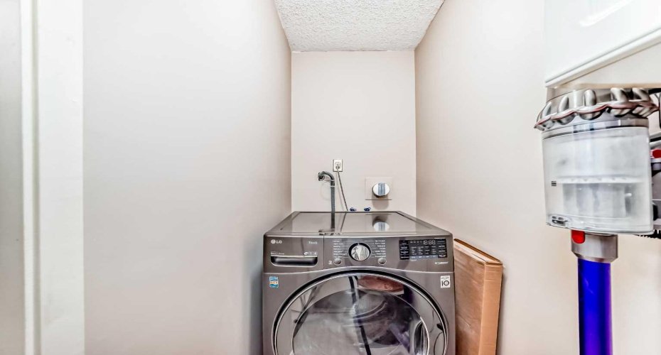In-suite laundry room with all-in-one washer/dryer.
