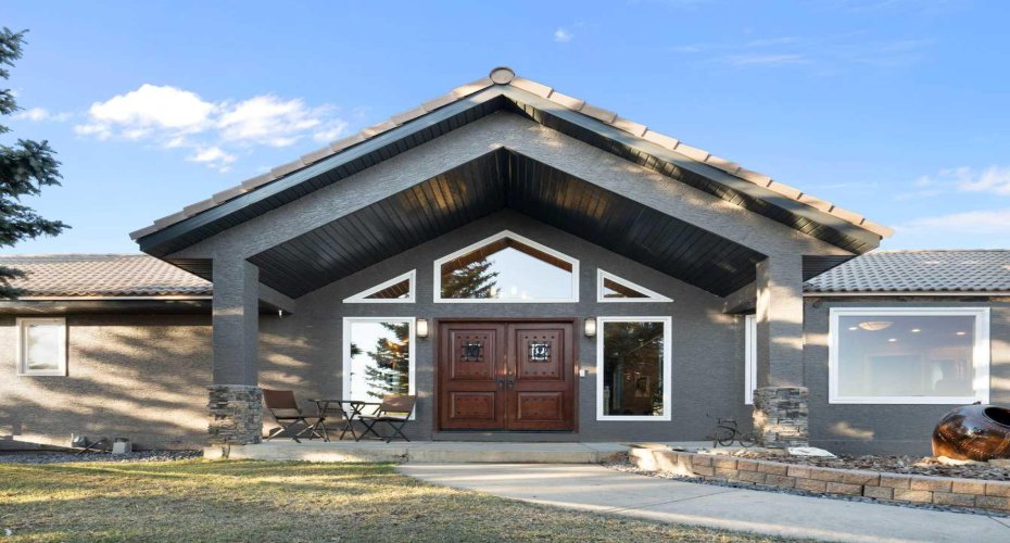 Front entrance with solid teak doors overlooking facility