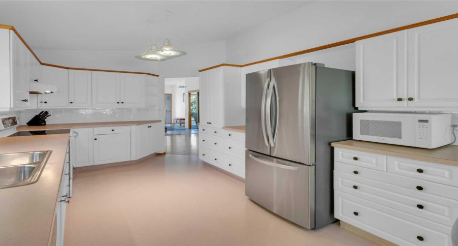 Spacious kitchen with white cabinetry
