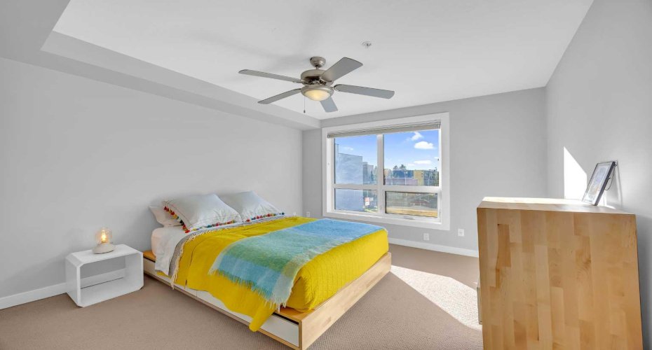 Primary bedroom with a walk-in closet