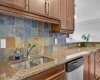 Kitchen features granite counters, stainless steel appliances and pantry