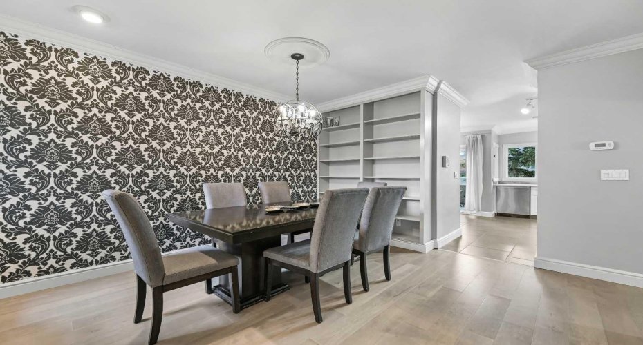 Elegant Dining Room just off the Kitchen with charming lighting fixture.