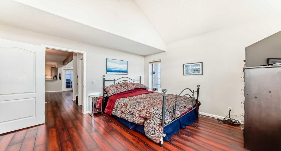 Tranquil primary bedroom with abundant natural light streaming through large windows, creating a bright and serene retreat.