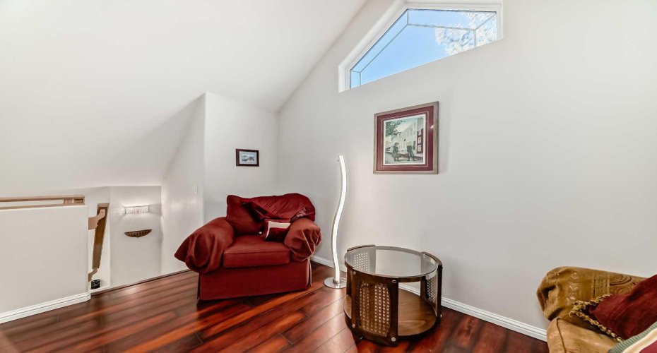 Versatile upstairs bonus room with abundant natural light, perfect for a home office or media space.