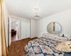 Second bedroom with ample natural light and neutral tones, offering comfortable space for guests or family.