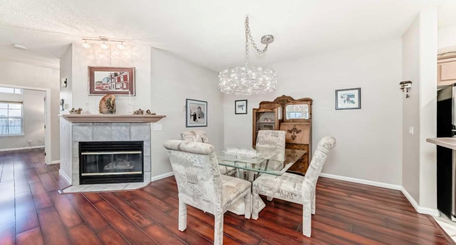 Inviting dining area accented by a cozy fireplace — a warm and welcoming space for meals and conversations.