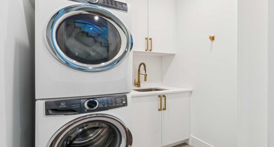 WALK-IN LAUNDRY ROOM WITH SINK AND STORAGE