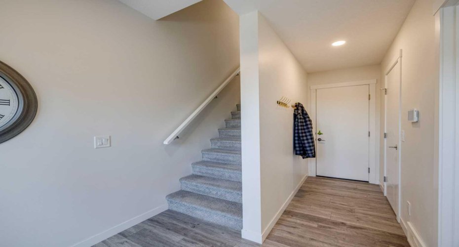 Hallway to garage and utility room as well as stairs to the main level.