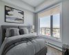 Bright primary bedroom with tray ceiling