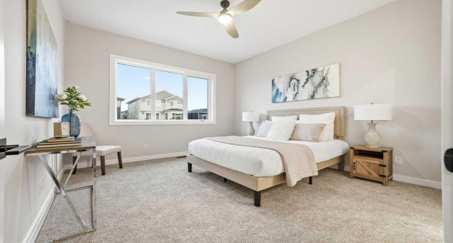 A spacious and serene primary bedroom.