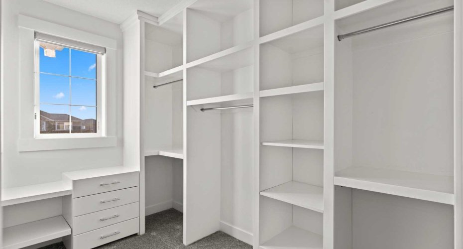 The secondary primary suite is further enhanced by a custom walk in closet with thoughtfully designed built ins, offering abundant storage and a polished, organized finish.
