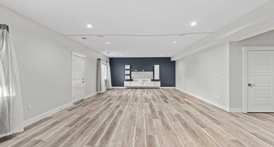 A second perspective highlights the generous seating area, perfect for hosting gatherings, cozy family movie nights, or simply unwinding in a spacious and inviting setting.