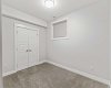 A comfortable basement bedroom featuring a generous closet offers ample storage and a private, versatile space ideal for guests, extended family, or rental use.