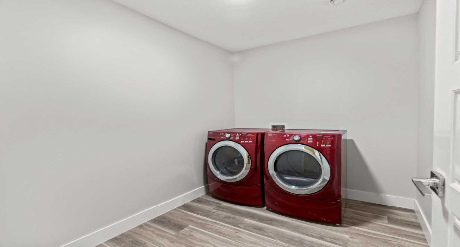 A dedicated basement laundry room complete with washer and dryer offers added practicality and convenience, keeping household tasks tucked away in a separate, functional space.