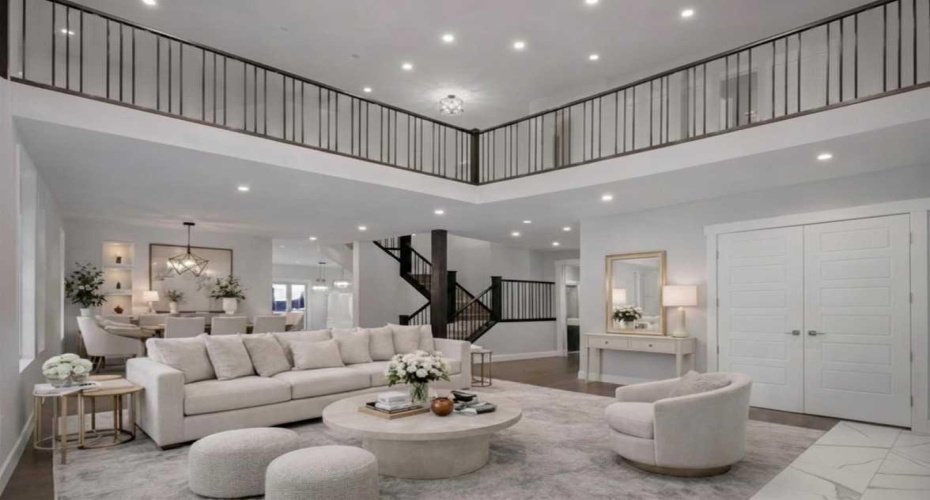 A grand double height foyer welcomes you with rich hardwood flooring, a ceramic tile entry, and an OPEN CONCEPT design that immediately showcases the scale, natural light, and architectural sophistication of this luxury residence.