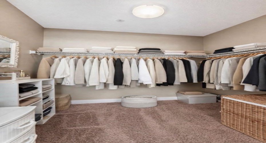 Truly generous walk-in closet designed to keep your wardrobe beautifully organized.