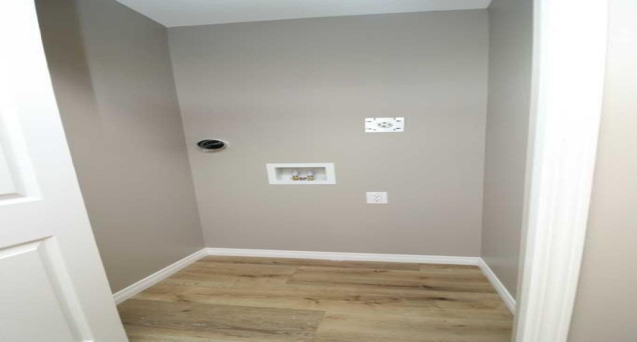 Mainfloor laundry. Primary/master bedroom.  Image from 443 Henricks Dr.
