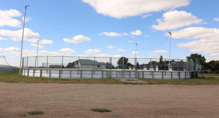 Community image outdoor rink walking distance, just East of the home in the photo. Or is that hollering distance? Your new home is visible in the background.