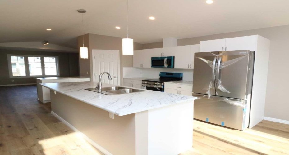 The kitchen and the living room.  Image from 443 Henricks Dr.