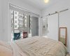 Primary bedroom with barn doors leading to private ensuite