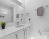 Main Bath with undercabinet lighting and quartz counters