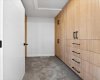 Primary walk in closet with built ins.