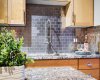 Industrial inspired faucet and tiled backsplash add to the urban loft feel of this great condo.