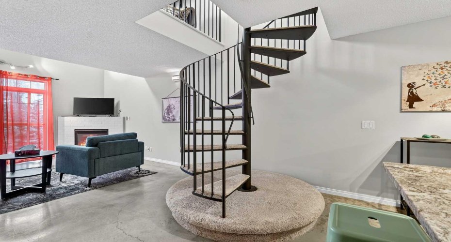 Spiral staircase is cool architectural feature, and takes up much less space than conventional staircase.