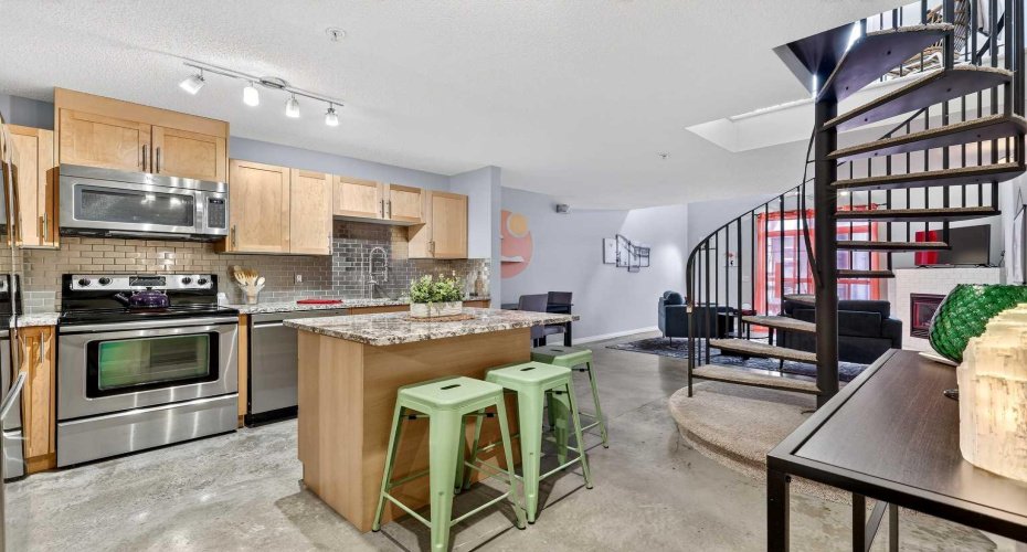 Kitchen with granite counters, maple cabinetry.