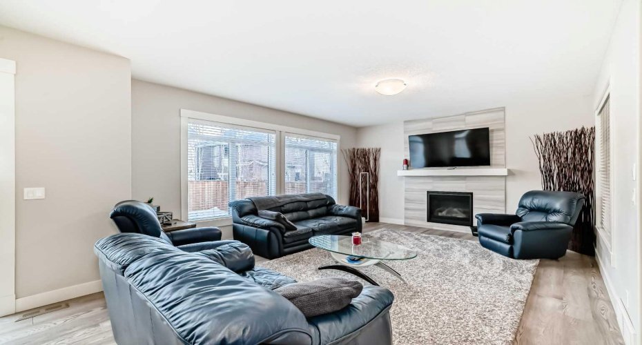 Central fireplace brings together the living room area.